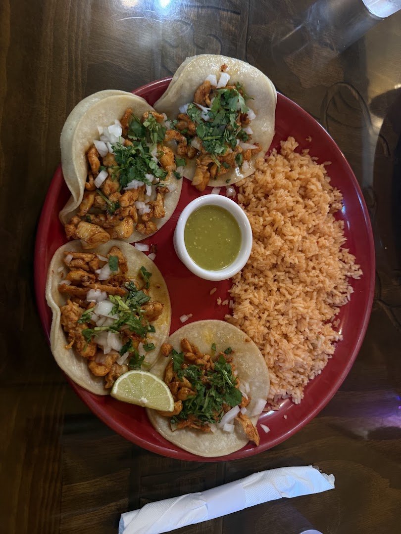 Plates of burritos and tacos on a table.