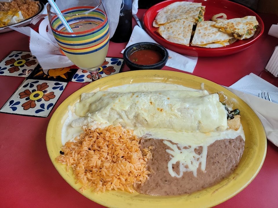 Menu close-up showing classic Mexican dishes and sides.